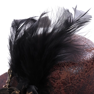 Close-up of steampunk mini hat with vintage bronze leather and black feathers