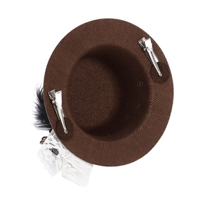 Detail view of mini brown top hat hair clip with gears, feathers and lace accents