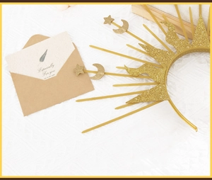 Detail view of golden sunburst halo crown with glitter stars and crescent moon