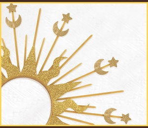 Macro view of gold celestial halo crown with stars, moon, and glittery details on white fabric