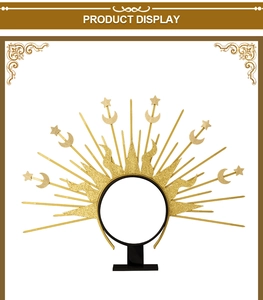 Detail view of golden sunburst crown featuring celestial star and moon elements