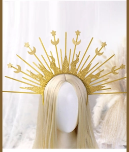 Macro shot of gold sunburst crown with stars and moon on a goddess headband