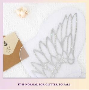 Close-up of white mesh fairy wings with silver glitter and elastic straps for kids
