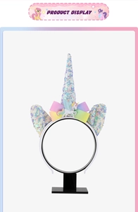 Detail of sequined unicorn headband with rainbow bow and cartoon pony accessory