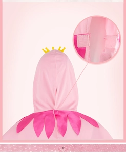 Detail of pink princess cloak featuring yellow crown decor and velcro closure for kids
