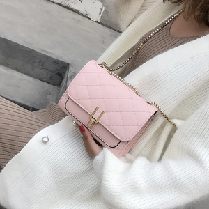 Pink quilted chain bag with gold Y-lock shown from above in a lifestyle street setting