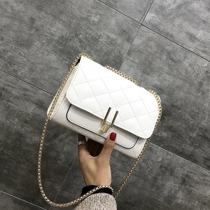 Detail showing white quilted PU leather texture with golden rectangular metal lock closure