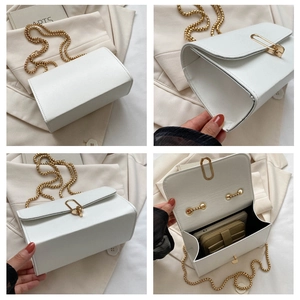 Detail view of white chain crossbody bag showing back, side, and spacious interior