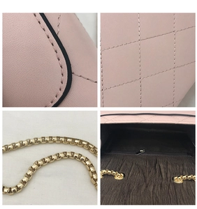 Detail view of pink quilted chain bag showing stitching texture and interior pocket