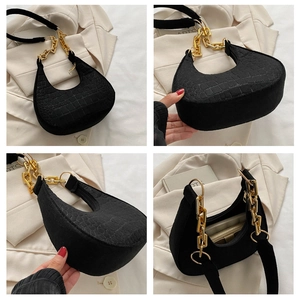 Detailed views of black crescent bag with crocodile texture and gold chain strap