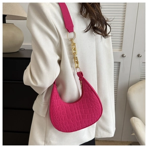 Detailed view of crocodile embossed shoulder bag with elegant gold chain strap