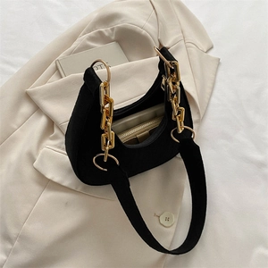 Detailed close-up of a black felt hobo bag with a stylish chunky gold chain handle