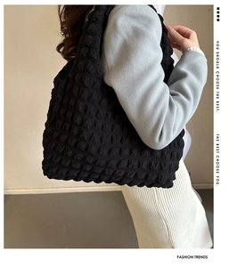 Detail of the black textured bubble fabric on a large capacity casual tote bag for women