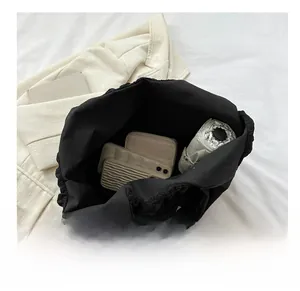 Internal view of black pleated cloud shoulder bag with large capacity for umbrella and wallet