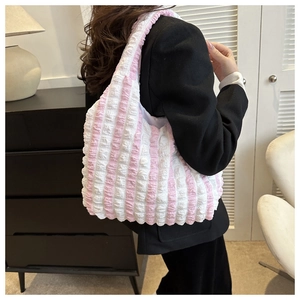 Detail view of pink and white striped bubble texture fabric on a large shoulder tote bag