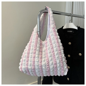 Detail of pink and white striped popcorn fabric tote bag with textured ruffles