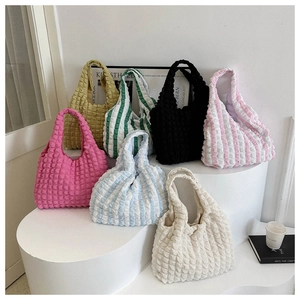 Detailed display of seven colorful pleated bubble tote bags in various solid and striped patterns