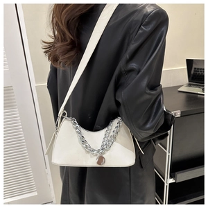Detailed view of cream white crescent shoulder bag with silver chunky chain and round pendant