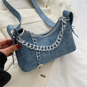 Detailed close-up of blue matte texture shoulder bag with silver chunky metal chain