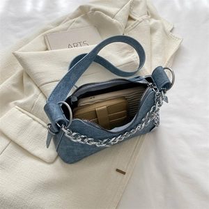 Top view of blue denim underarm bag showing interior space for phone and wallet