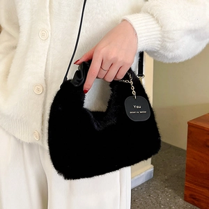 Chic black faux fur crossbody bag with leather strap and motivational metal tag