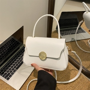 Minimalist white leather handbag with round gold buckle and curved handle
