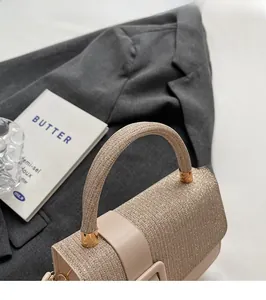 Detail of glitter champagne handbag with gold buckle on a stylish suit background