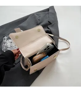 Interior view showing the spacious capacity of a beige PU leather crossbody bag