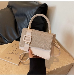 Detail of glittery champagne PU crossbody bag with rhinestone handle and square buckle