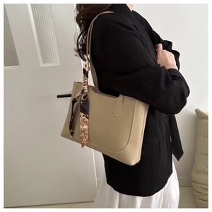 Detail of khaki tote bag with contrast stitching and vintage silk scarf handle wrap