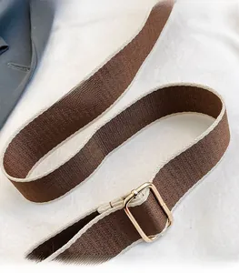 Adjustable wide woven shoulder strap in brown and beige with a gold metal buckle detail
