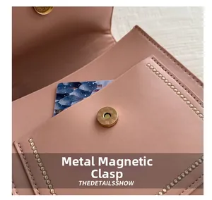 Close-up of pink leather bag interior featuring a golden magnetic clasp and card slot