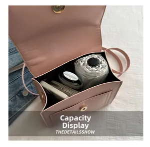 Pink crossbody bag interior showing spacious capacity for umbrella, phone, and wallet
