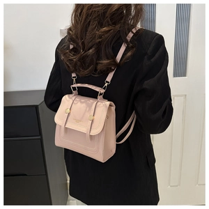 Detail of pink PU leather mini backpack with gold rivets and adjustable straps