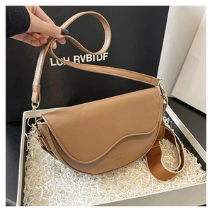 Detail of camel saddle bag featuring dual straps in a premium gift box presentation