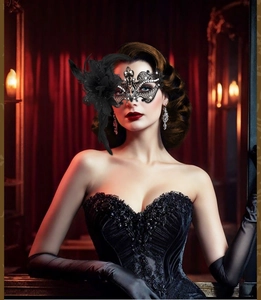 Close-up of black lace masquerade mask with ornate feathers and sparkling rhinestones