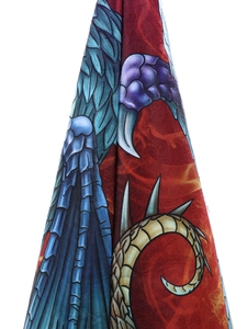 Detailed macro view of the intricate dragon wing and golden tail patterns on a witch hat