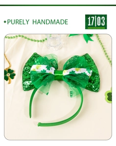 Detail of handmade St. Patrick's Day headband with green sequin bow and clover patterns