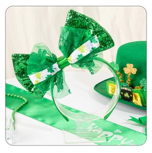 Close-up of St. Patrick's Day headband with green sequin bow and clover pattern details