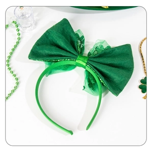 Detail of St. Patrick's Day green velvet bow headband with shamrock party decorations