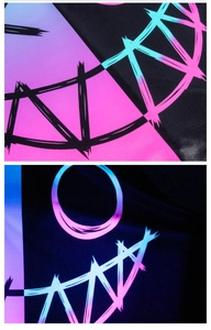 Close-up of Harley Quinn style digital print fabric with neon monster graffiti detail