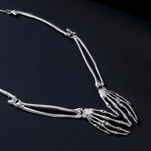 Detailed close-up of gothic silver alloy skeleton arm and hand bone necklace