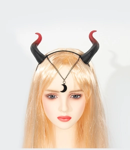 Detail of red and black gradient devil horn headband with crescent moon charm and metal chain