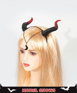 Detail of red and black gradient devil horn headband with moon pendant on model