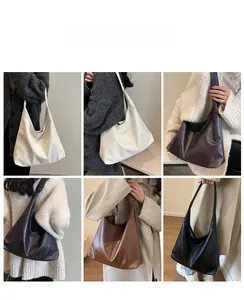 Detail view of large capacity faux leather hobo bags in white, brown, and black colors