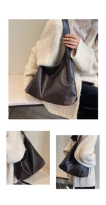 Close-up of a large dark brown leather hobo tote bag featuring a glossy texture and wide strap