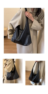 Detailed view of large black faux leather tote bag showing soft texture and hobo shape