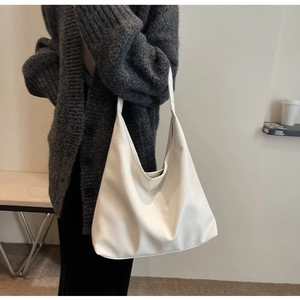Minimalist white leather tote bag with lychee texture shown on model for daily commute