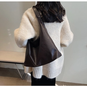 Deep brown glossy PU leather tote bag shown on model for a vintage autumn style look