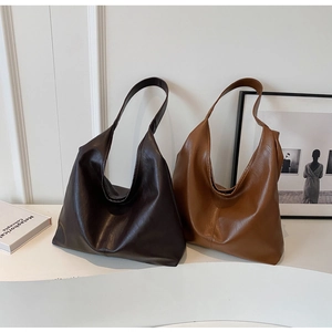 Minimalist leather shoulder tote bag detail in dark brown and caramel tan colors
